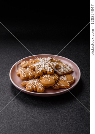 Christmas winter gingerbread, holiday biscuits on monochrome background Christmas winter gingerbread, holiday biscuits on monochrome background 128834047