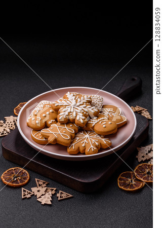 Christmas winter gingerbread, holiday biscuits on monochrome background 128834059