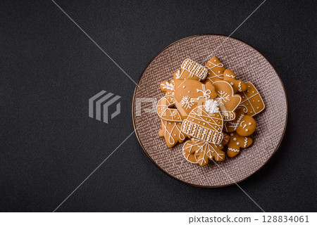 Christmas winter gingerbread, holiday biscuits on monochrome background Christmas winter gingerbread, holiday biscuits on monochrome background 128834061