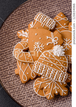 Christmas winter gingerbread, holiday biscuits on monochrome background Christmas winter gingerbread, holiday biscuits on monochrome background 128834066