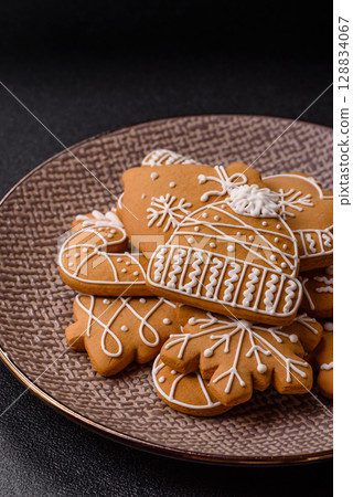 Christmas winter gingerbread, holiday biscuits on monochrome background Christmas winter gingerbread, holiday biscuits on monochrome background 128834067