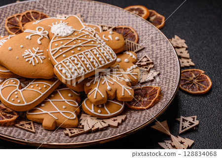 Christmas winter gingerbread, holiday biscuits on monochrome background Christmas winter gingerbread, holiday biscuits on monochrome background 128834068