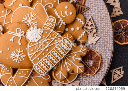 Christmas winter gingerbread, holiday biscuits on monochrome background Christmas winter gingerbread, holiday biscuits on monochrome background 128834069