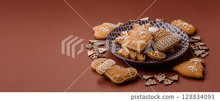 Christmas winter gingerbread, holiday biscuits on monochrome background Christmas winter gingerbread, holiday biscuits on monochrome background 128834091