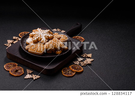 Christmas winter gingerbread, holiday biscuits on monochrome background Christmas winter gingerbread, holiday biscuits on monochrome background 128834117