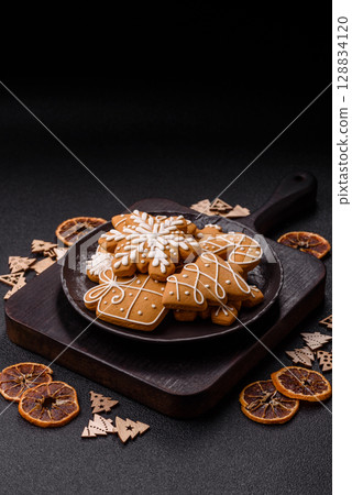 Christmas winter gingerbread, holiday biscuits on monochrome background Christmas winter gingerbread, holiday biscuits on monochrome background 128834120