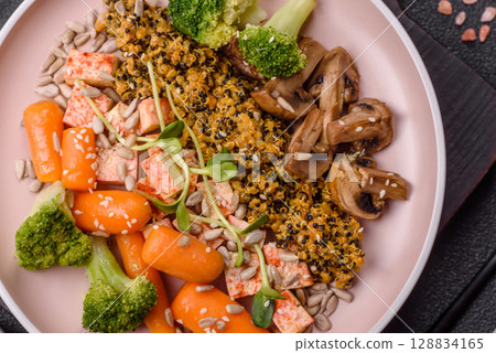 Food bowl with tofu, quinoa, broccoli and carrots, microgreens 128834165