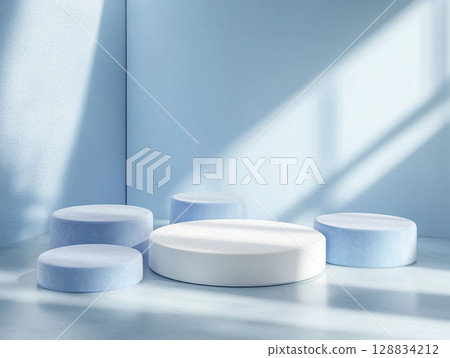 A serene product display featuring a variety of white cylindrical and rectangular podiums and a large circle against a soft blue arched backdrop. 128834212