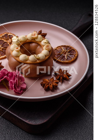 Round chocolate tart or pie with cream berry filling 128834526