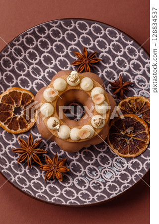 Round chocolate tart or pie with cream berry filling 128834537