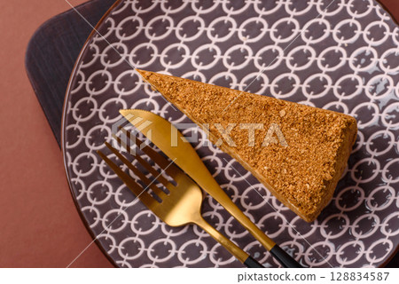 A slice of honey puff cake or pumpkin, carrot and cream pie, vegan sweets A slice of honey puff cake or pumpkin, carrot and cream pie, vegan sweets 128834587