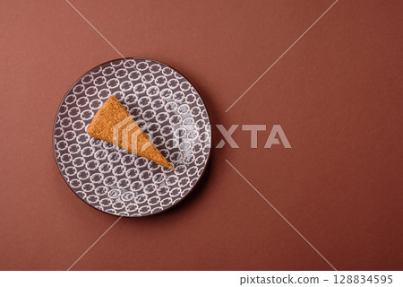 A slice of honey puff cake or pumpkin, carrot and cream pie, vegan sweets 128834595