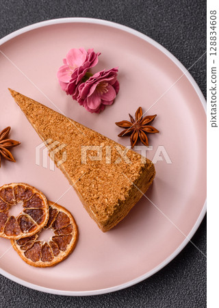 A slice of honey puff cake or pumpkin, carrot and cream pie, vegan sweets 128834608