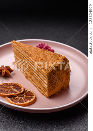 A slice of honey puff cake or pumpkin, carrot and cream pie, vegan sweets 128834609