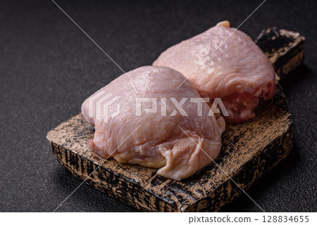 Chicken thigh raw, fresh poultry meat with salt and spices Chicken thigh raw, fresh poultry meat with salt and spices 128834655