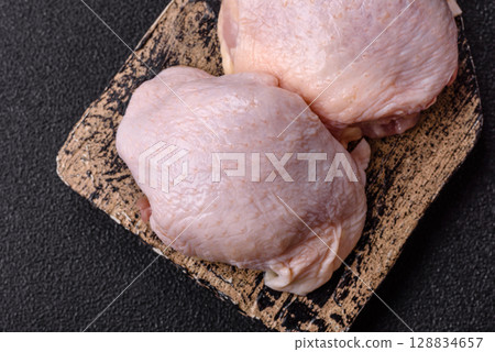 Chicken thigh raw, fresh poultry meat with salt and spices 128834657
