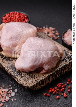 Chicken thigh raw, fresh poultry meat with salt and spices Chicken thigh raw, fresh poultry meat with salt and spices 128834666