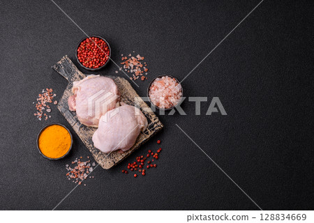 Chicken thigh raw, fresh poultry meat with salt and spices Chicken thigh raw, fresh poultry meat with salt and spices 128834669