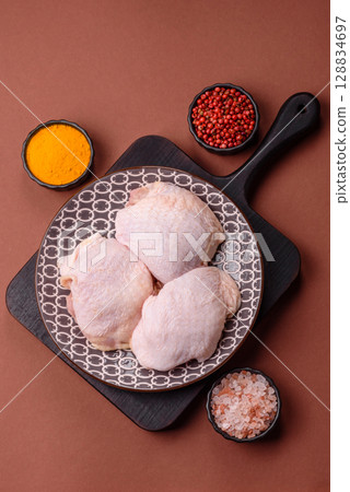 Chicken thigh raw, fresh poultry meat with salt and spices 128834697