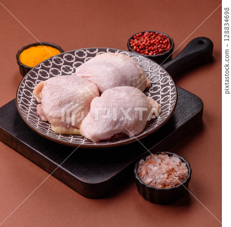 Chicken thigh raw, fresh poultry meat with salt and spices 128834698