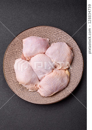 Chicken thigh raw, fresh poultry meat with salt and spices Chicken thigh raw, fresh poultry meat with salt and spices 128834739