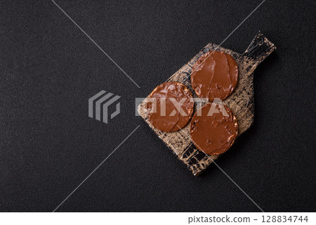 Matzah with chocolate paste for the Jewish holiday of passover 128834744