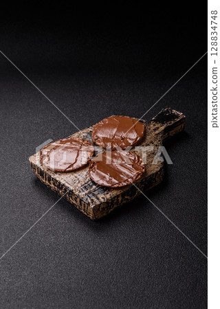 Matzah with chocolate paste for the Jewish holiday of passover Matzah with chocolate paste for the Jewish holiday of passover 128834748