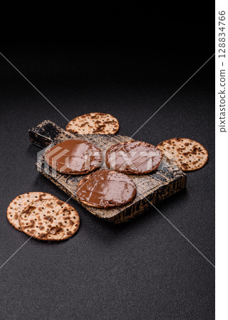 Matzah with chocolate paste for the Jewish holiday of passover 128834766