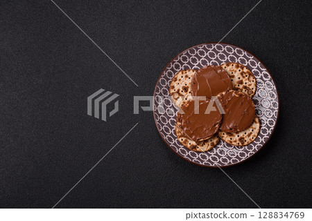 Matzah with chocolate paste for the Jewish holiday of passover 128834769