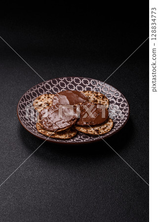 Matzah with chocolate paste for the Jewish holiday of passover 128834773