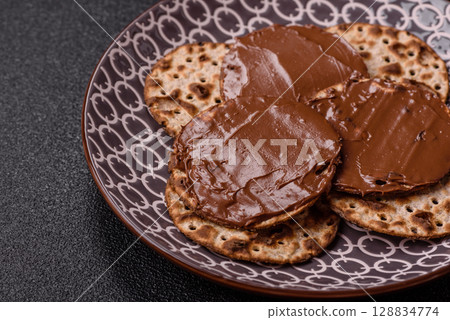 Matzah with chocolate paste for the Jewish holiday of passover 128834774