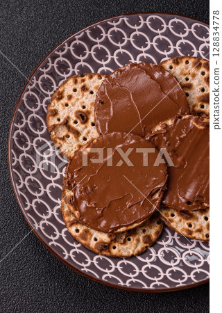 Matzah with chocolate paste for the Jewish holiday of passover 128834778