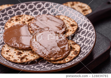 Matzah with chocolate paste for the Jewish holiday of passover 128834781