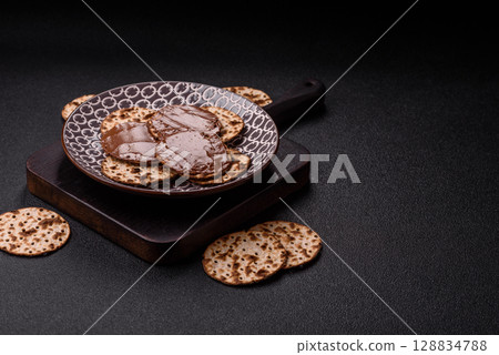 Matzah with chocolate paste for the Jewish holiday of passover 128834788
