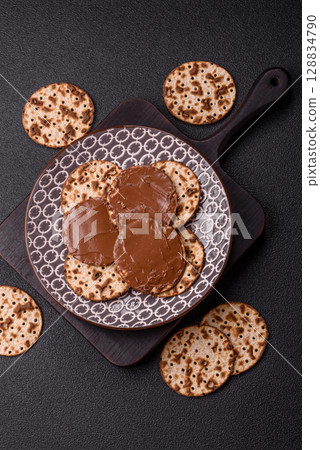 Matzah with chocolate paste for the Jewish holiday of passover 128834790