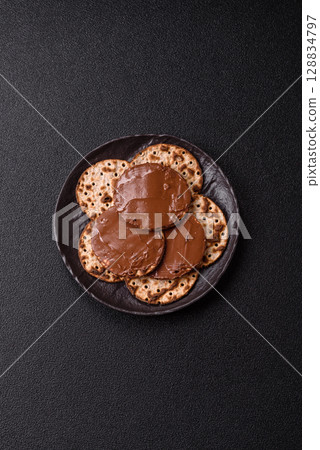 Matzah with chocolate paste for the Jewish holiday of passover Matzah with chocolate paste for the Jewish holiday of passover 128834797