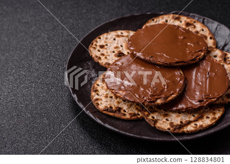 Matzah with chocolate paste for the Jewish holiday of passover 128834801