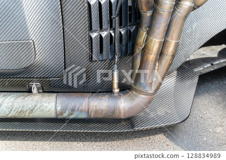 Exhaust system with lambda sensor and carbon fiber body in a sports car Exhaust system with lambda sensor and carbon fiber body in a sports car 128834989