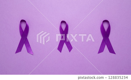 Purple ribbon held, symbol of support. Purple Epilepsy Awareness Day Purple ribbon held, symbol of support. Purple Epilepsy Awareness Day 128835234