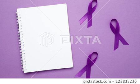 Purple ribbon held, symbol of support. Purple Epilepsy Awareness Day. Mock up notebook Purple ribbon held, symbol of support. Purple Epilepsy Awareness Day. Mock up notebook 128835236