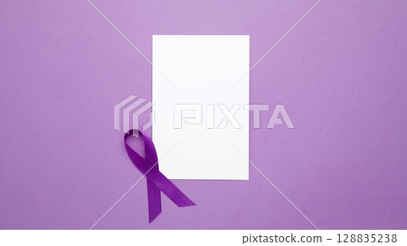 Purple ribbon held, symbol of support. Mock up notebook. Purple Epilepsy Awareness Day Purple ribbon held, symbol of support. Mock up notebook. Purple Epilepsy Awareness Day 128835238