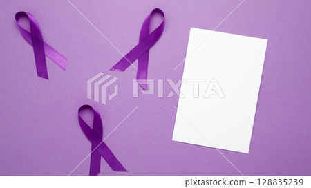 Mock up notebook. Purple Epilepsy Awareness Day, purple ribbon held, symbol of support Mock up notebook. Purple Epilepsy Awareness Day, purple ribbon held, symbol of support 128835239