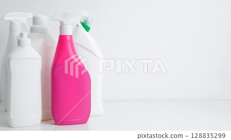 Various cleaning supplies on white background symbolizing spring cleaning. Household cleaning and hygiene concept 128835299