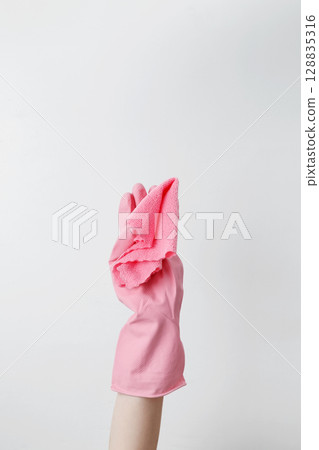 Blue cleaning products, the woman cleans using rubber gloves and a microfiber cloth. Household cleaning and hygiene concept Blue cleaning products, the woman cleans using rubber gloves and a microfiber cloth. Household cleaning and hygiene concept 128835316