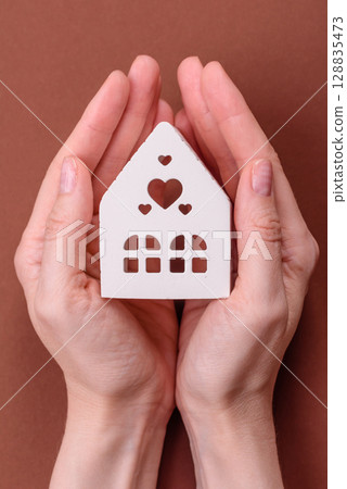 Home, house, buying property for business or life. Concept with human hand Home, house, buying property for business or life. Concept with human hand 128835473