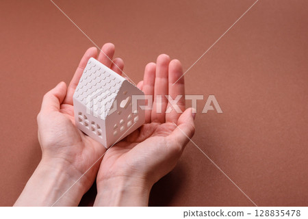 Home, house, buying property for business or life. Concept with human hand Home, house, buying property for business or life. Concept with human hand 128835478