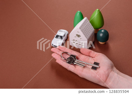 Home, house, buying property for business or life. Concept with human hand Home, house, buying property for business or life. Concept with human hand 128835504