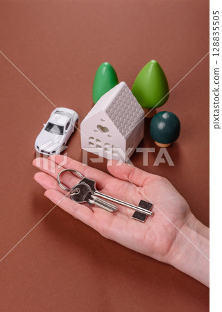 Home, house, buying property for business or life. Concept with human hand Home, house, buying property for business or life. Concept with human hand 128835505