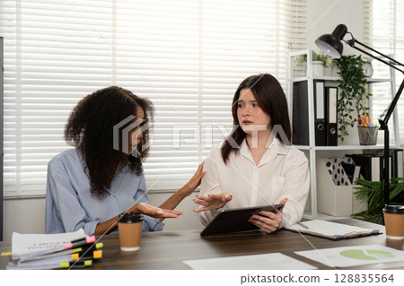 Engaging Discussion Between Colleagues in Bright Office 128835564