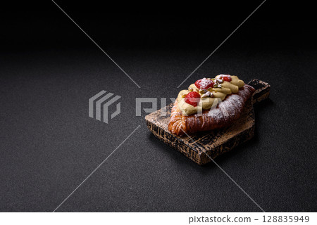 Food for breakfast sweet strawberry croissants with chocolate filling 128835949